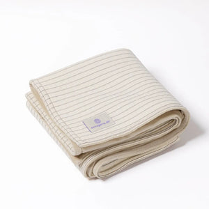 Folded cream Emagene Life striped blanket on white background, functional medicine product