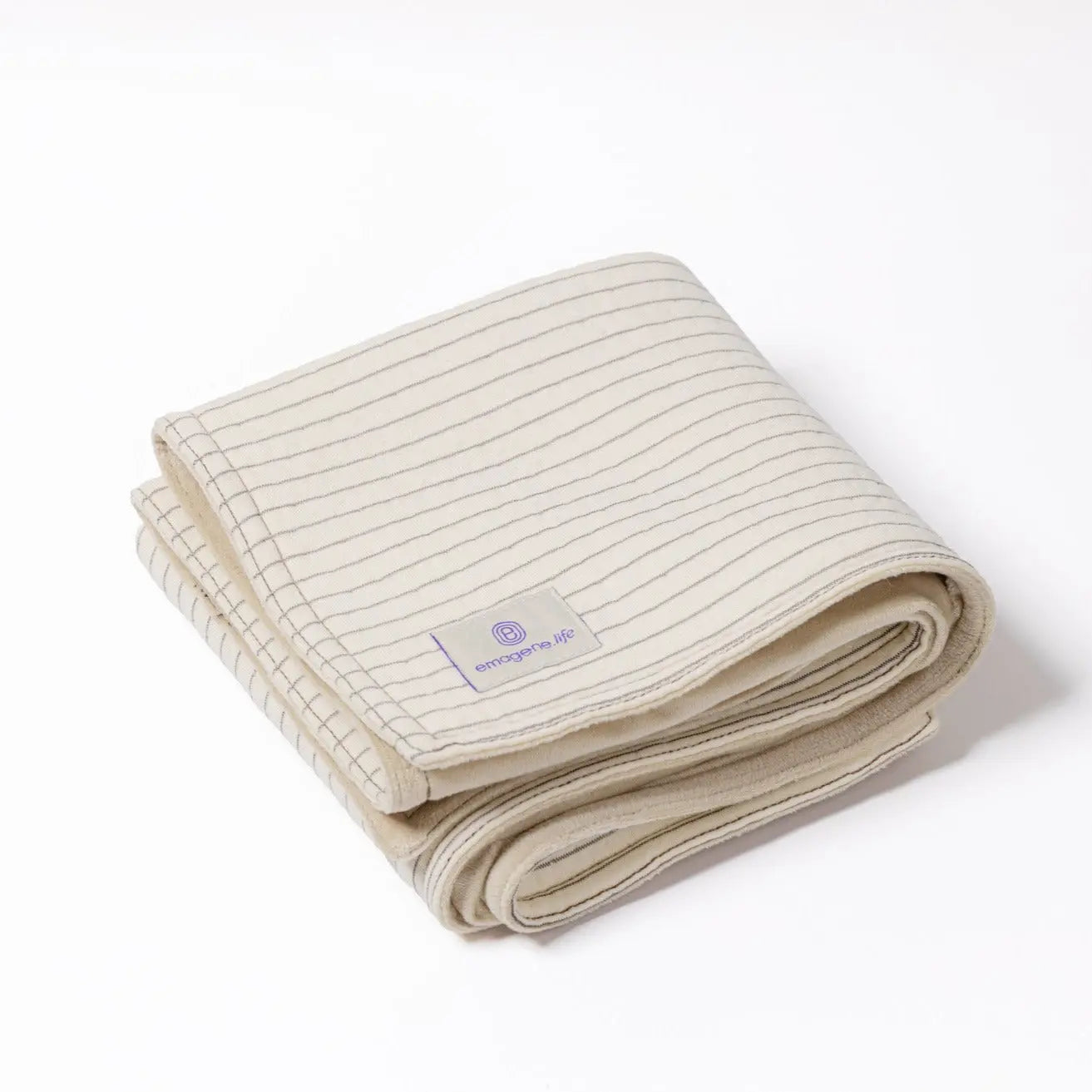 Folded cream Emagene Life striped blanket on white background, functional medicine product