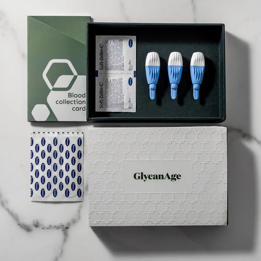 GlycanAge blood test kit with collection card, lancets, antiseptic wipes on marble surface